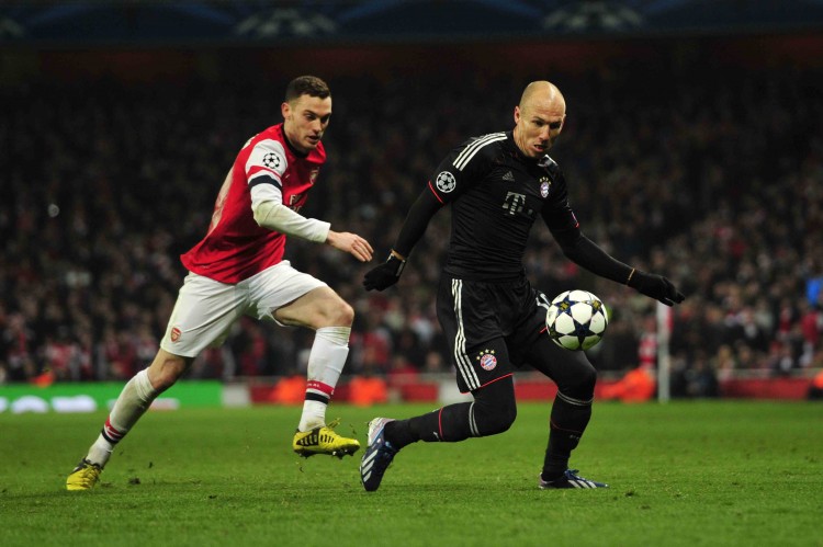 Bayern Munich winger Arjen Robben evades Arsenal defender Thomas Vermaelen at the Emirates Stadium in London, England in Champions League action on Feb. 19. (Glyn Kirk/AFP/Getty Images) 