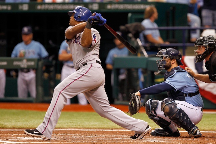 Adrian Beltre hits his second of three home runs Tuesday in the fourth inning - a solo shot that put the Rangers up 3-1 in route to ending Tampa Bay's season with a 4-3 win. (Mike Ehrmann/Getty Images)