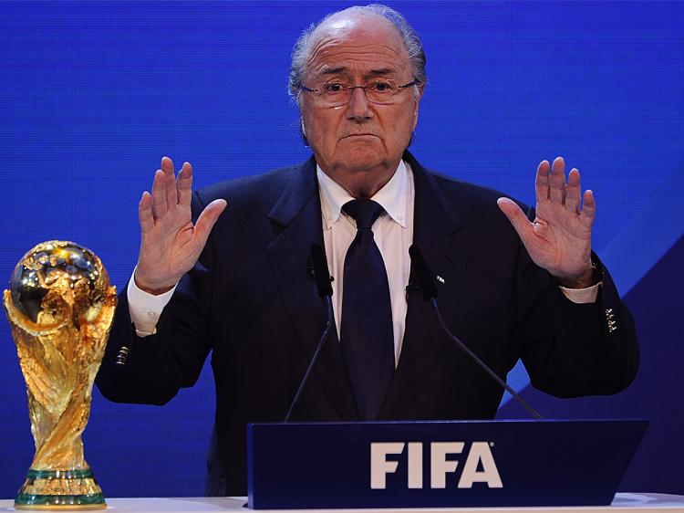 WORLD CUP WINNERS: FIFA President Joseph Blatter quiets the crowd before announcing that Russia and Qatar will host the 2018 and 2022 World Cup tournaments. (Fabrice Coffrini/AFP/Getty Images)