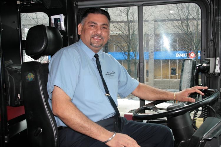 Dave Rai in the bus he drives for West Vancouver Blue Bus Transit. (Andrea Hayley/The Epoch Times)