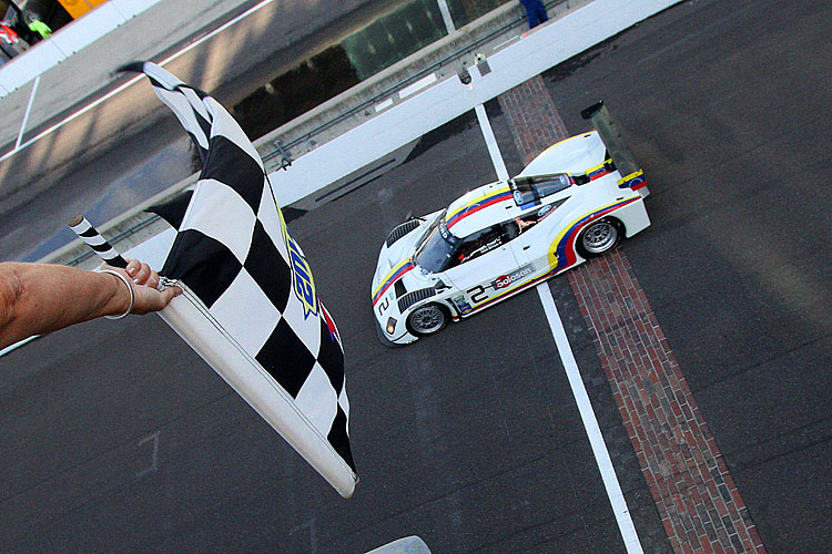 Sebastian Bourdais takes the checkered flag at the Rolex Brickyard grand Prix for himself, co-driver Alex Popow, ands Starworks Racing. (Grand-Am.com)