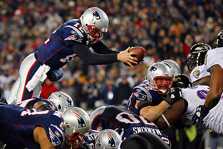 Tom Brady scored what turned out to be the game-winning touchdown with this fourth-quarter dive over the Raven defense. (Elsa/Getty Images) 