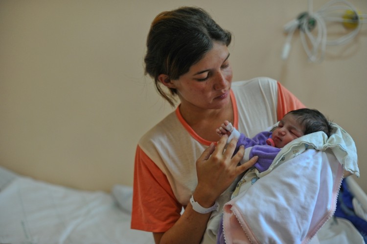 A Brazilian mother holds her newborn baby at Amparo Maternal hospital in São Paulo, Brazil, on Oct. 31, 2011. The rate of c-sections in Brazil is almost three times as the maximum rate recommended by the World Health Organization. (Yasuyoshi Chiba/AFP/Getty Images)