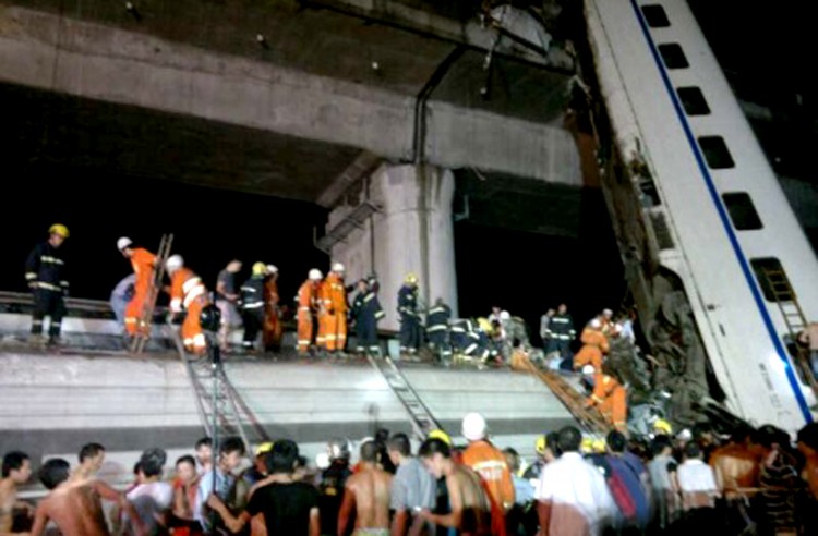 Firefighters rescue survivors of a high-speed train accident in which two train carriages derailed and fell off a bridge, in eastern China's Zhejiang province, on July 23, 2011.  (STR/AFP/Getty Images)
