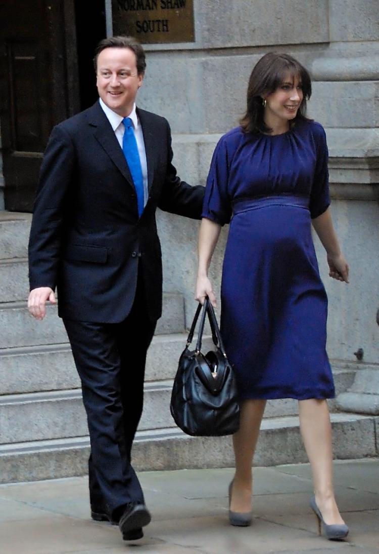 David Cameron heads out of Conservative Party headquarters with his pregnant wife Samantha on his way to the Queen at Buckingham palace. The Queen formally asked him to form the next government as prime minister. (Edward Stephen/Epoch Times)