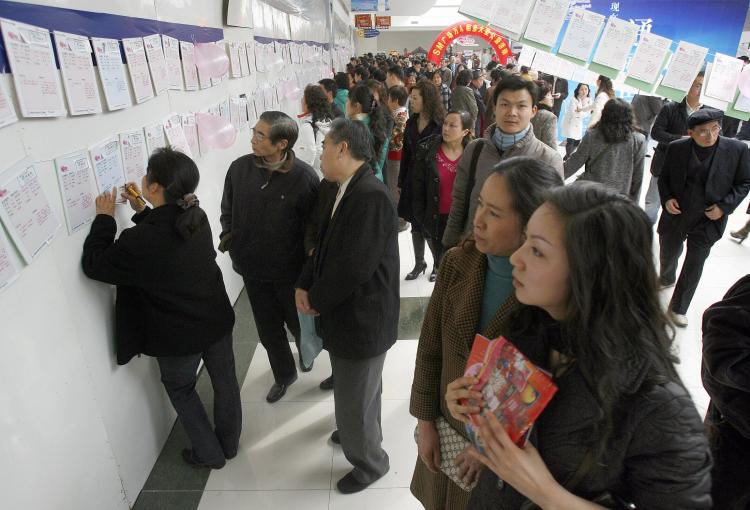 Locals browse through singles information at a 'lover's finding,' or matchmaking event for Valentines Day in Chengdu, Sichuan Province, in 2007. (AFP/Getty Images)