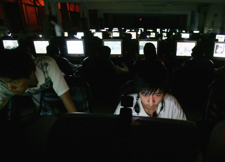 A young man in a cyber cafe sits at a computer. A recent, extensive interview reveals in depth how the sophisticated operation of deception, or 'public opinion channeling' in the words of Party leader Hu Jintao, plays out across the Internet. (Cancun Chu/Getty Images)