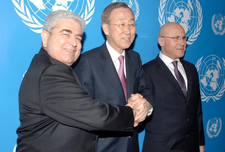 Cypriot President Demetris Christofias (L) and Turkish Cypriot leader Mehmet Ali Talat (R) hold hands with U.N. Secretary-General Ban Ki-moon as they pose for a picture during a joint press conference in Nicosia on Feb. 1, 2010.  (Stefanos Kouratzis/AFP/Getty Images)