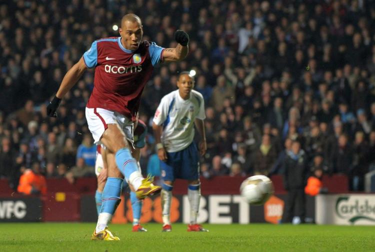 Aston Villa's John Carew completes his hat trick. (Paul Ellis/AFP/Getty Images)