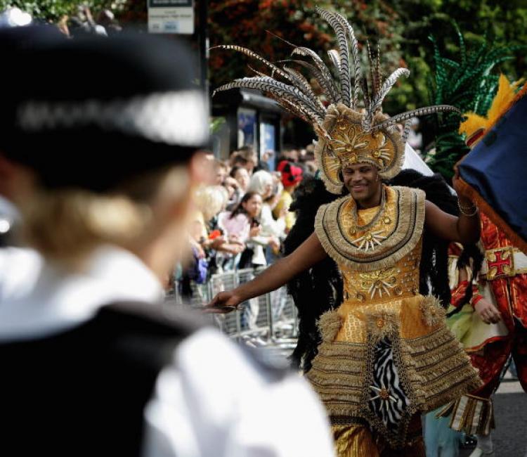 Dancers are watched over by police as they take part in the Carnival Parade during the annual Notting Hill Carnival in 2006 (Chris Jackson/Getty Images ) Dancers are watched over by police as they take part in the Carnival Parade during the annual Notting Hill Carnival in 2006 (Chris Jackson/Getty Images )