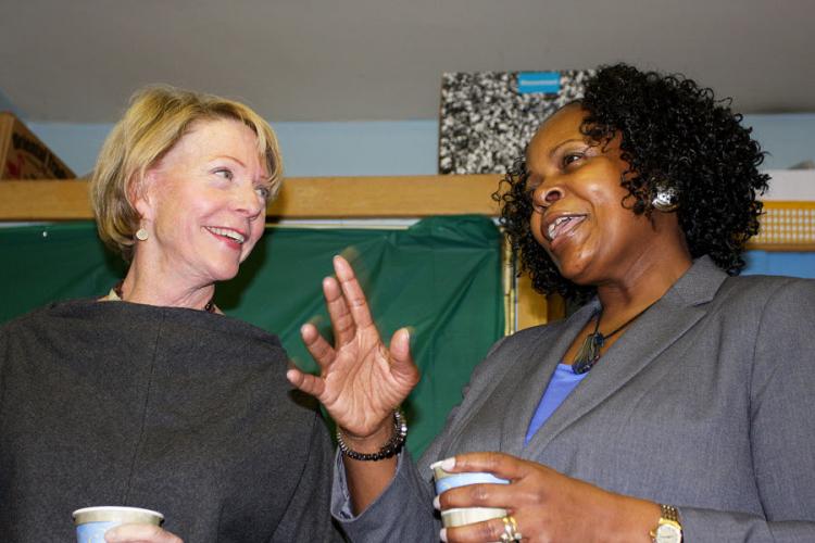 TO THE PRINCIPAL'S OFFICE: Cathie Black (L) mingles with educators and parents, including the principal of PS 626, Joletha Ferguson (R). (Tara MacIsaac/ The Epoch Times)