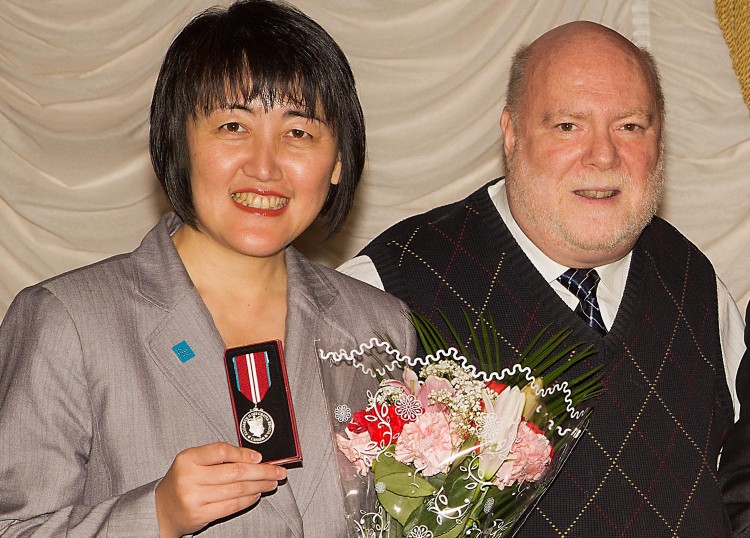 Epoch Times publisher Cindy Gu stands with Sanderson Layng, Vice President and Chief Operating Officer of the Canadian Centre for Abuse of Awareness (CCAA)