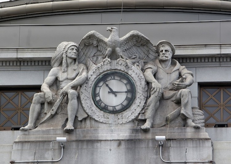 GUARDING TIME: Two sculptured figures above the main entrance on the bank's east facade were created by Charles Keck.  (Tim McDevitt/The Epoch Times)
