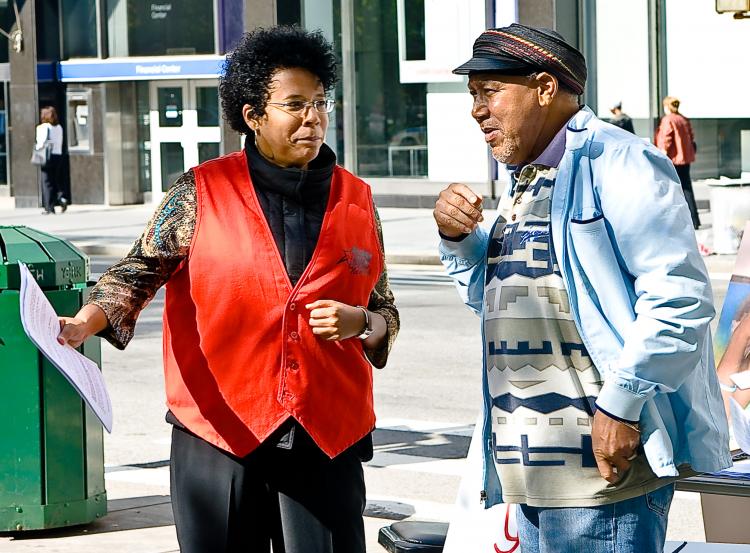 COMMUNITY EFFORT: Pam Lewis (Left) explains the situation of the Redfern Community Center to a passerby. The City is planning on closing the Far Rockaway Community Center, a safe haven for teens in the area. (JOSHUA PHILIPP/THE EPOCH TIMES)