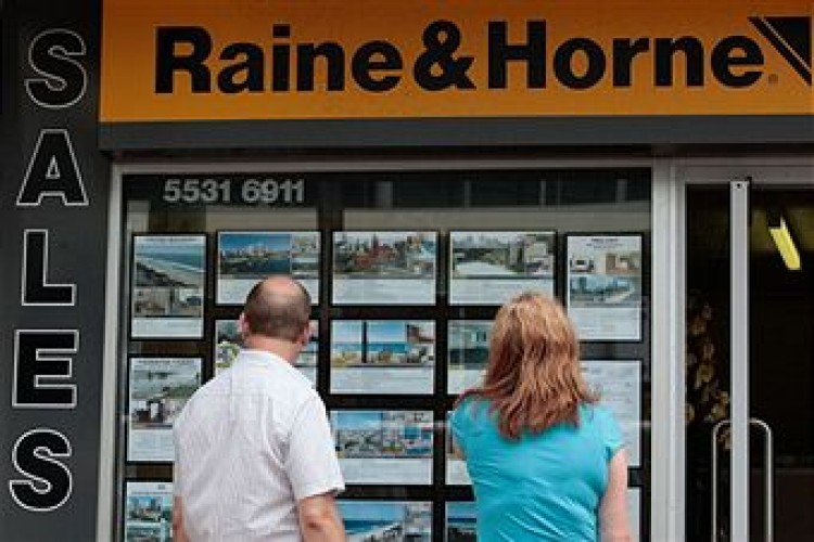 A couple looks at listings in a Gold Coast suburb in Australia, on March 29, 2011. Australia's housing is the most overvalued in the world, the Economist newspaper said last month. (Bloomberg/Getty Images)