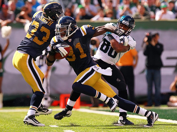 Antonio Cromartie returns one his two interceptions on the day against Jacksonville starter Luke McCown. All in all, the Jets' cornerback (wearing the throw-back blue and yellow uniform) totaled 148 return yards in running back the aforementioned pair of picks plus his two kick returns in the Jets' 32-3 win over Jacksonville. (Nick Laham/Getty Images)