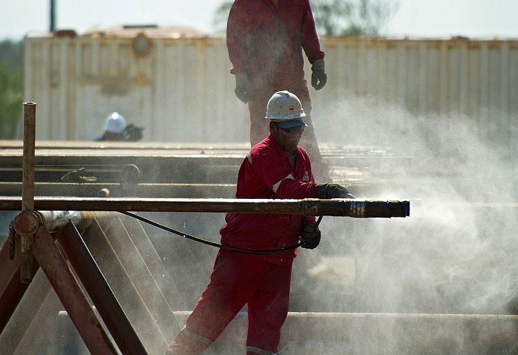 Employees work in an oil rig operated by Cuba and China