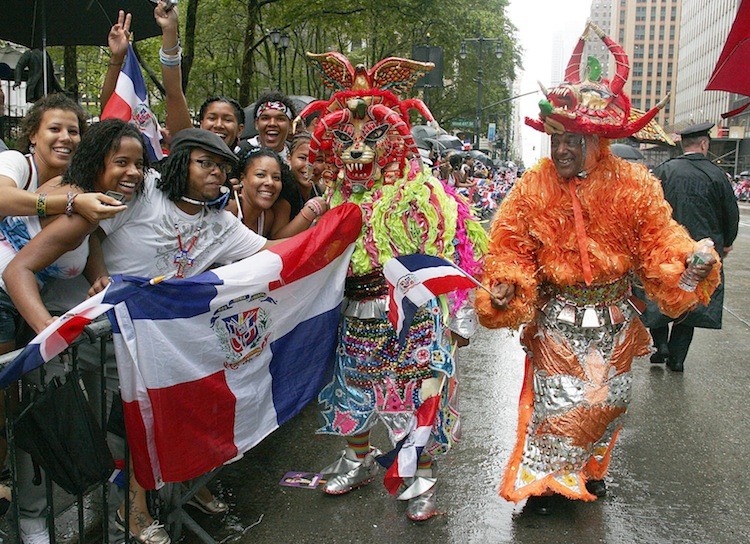 TRADITIONAL CELEBRATION: Parade participants in carnival suits and masks interact with the crowd at the Dominican Day Parade in Midtown Manhattan on Sunday.  (Ivan Pentchoukov/The Epoch Times)