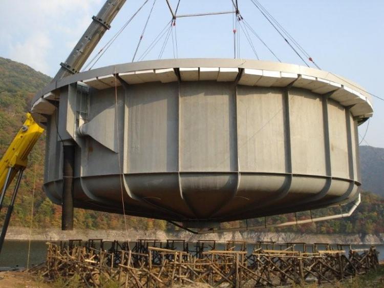 A crane moves AgriMarine's commercial fish tank from land to water in Benxi, China.  (Larry Albright)