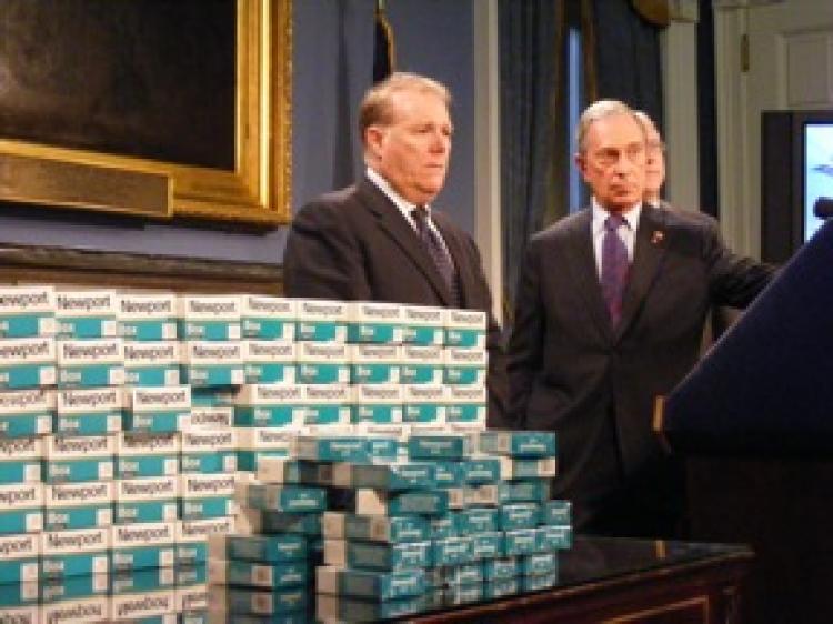 WE GOT 'EM: Chief Policy Adviser John Feinblatt (L) and Mayor Michael Bloomberg present untaxed cigarette packs that were captured in an undercover operation at the Poospatuck Reservation on Long Island. (Gidon Belmaker/Epoch Times Staff)