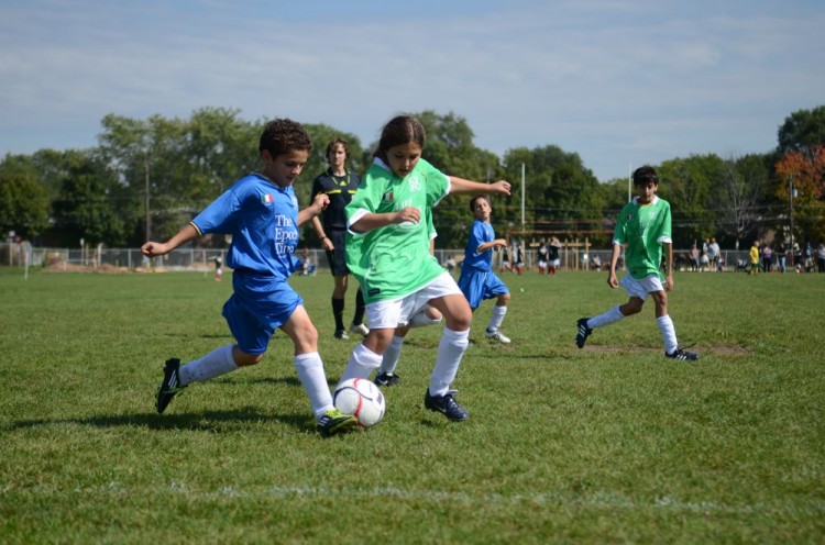 A player form The Epoch Times Team Italy works to get the ball around a Life Choices Food Team Ireland player.  (The Epoch Times)