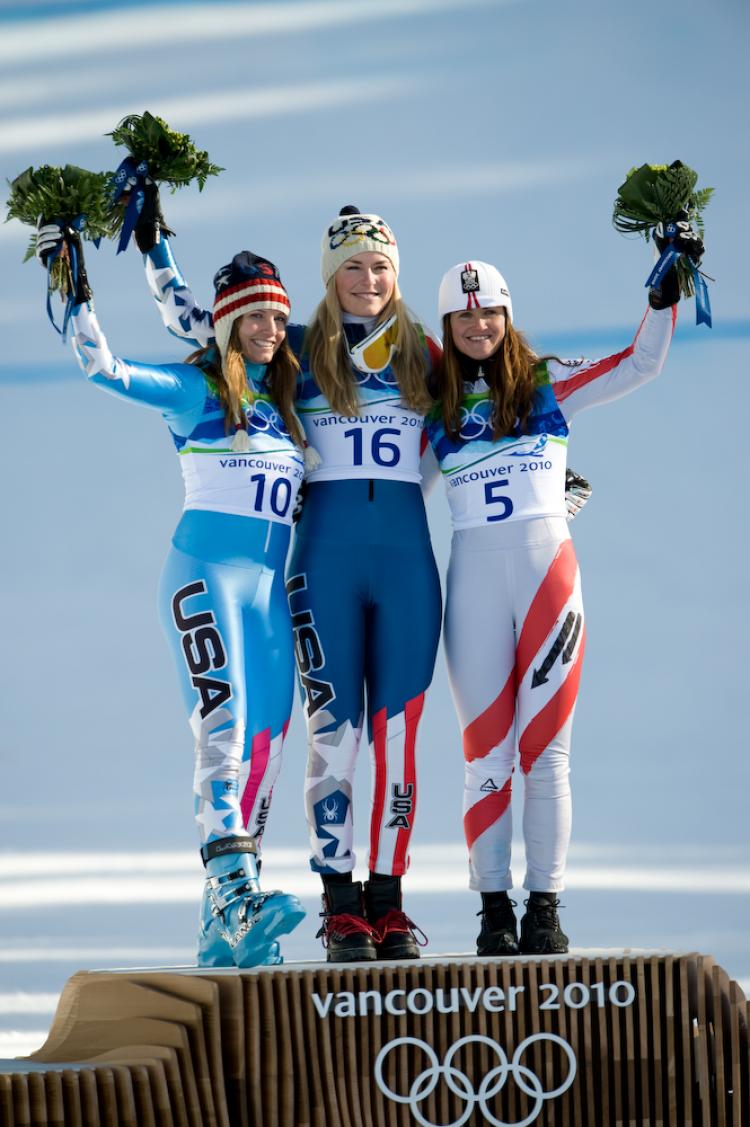 WINNERS: (L-R) American Julia Mancuso, American Lindsey Vonn, and Austrian Elisabeth Goergl stand on the podium of flower ceremony after competing in ladies' downhill alpine skiing.  (Evan Ning/The Epoch Times)