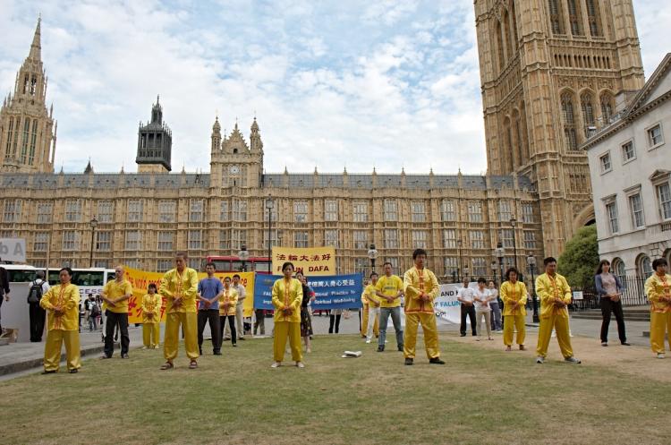 Falun Gong practitioners demonstrate their slow moving exercises outside the Houses of Parliament on Tuesday July 20th. The event marked 11 years of persecution against the group in China, which has seen thousands tortured to death. (Edward Stephen/Epoch Times)
