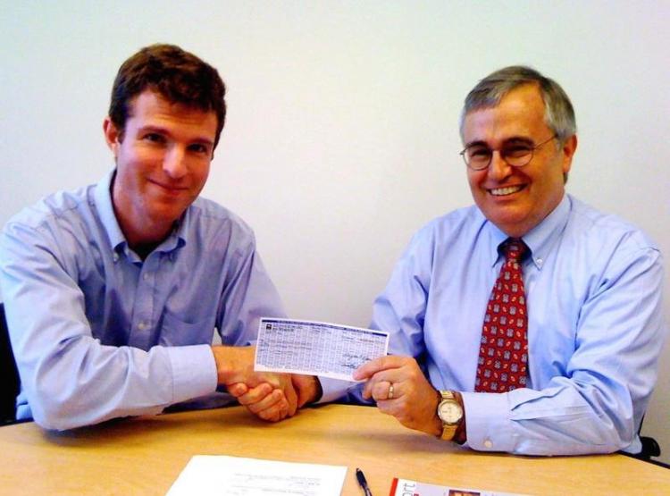 Daniel Gilbert (l) gives Al Cross, director of the Institute for Rural Journalism and Community Issues, a check for $10,000 to launch the Rural Computer-Assisted Reporting.  (Courtesy of Daniel Gilbert)