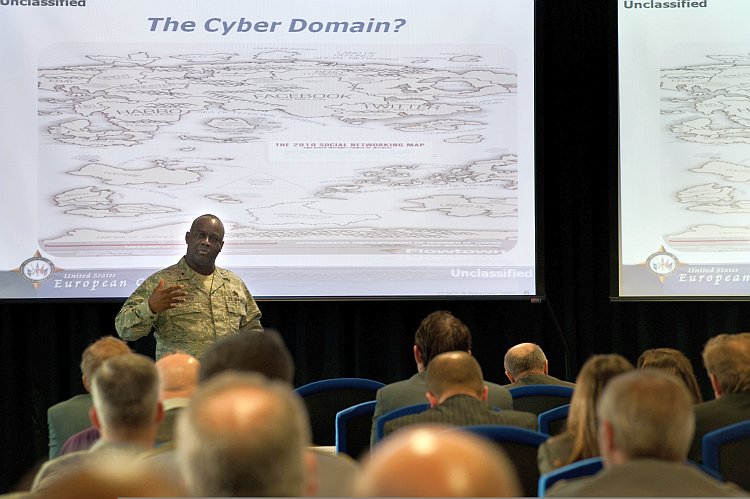 U.S. Air Force Gen. Gregory L. Brundidge (L) speaks at the Cyber Defense