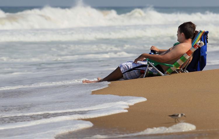 People in beach chairs watch the high surf caused by Hurricane Earl on Sept. 1 in Kitty Hawk, N.C. (Mark Wilson/Getty Images)