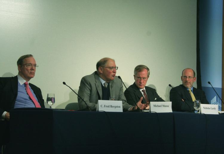 GLOBAL GROWTH: Four economists at the Peterson Institute for International Economics (PIIE) are optimistic for global economic growth in 2011 and 2012, and spoke at a luncheon April 4 at PIIE. From left to right are: C. Fred Bergsten, director of PIIE since 1981; Michael Mussa, senior fellow and former chief economist at the IMF; Nicholas Lardy, senior fellow; and Marcus Noland, senior fellow and deputy director of PIIE.  (Gary Feuerberg/The Epoch Times)