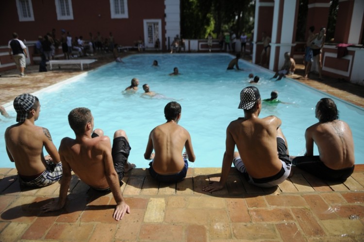 Young people rest by a pool during a sit-in designed to draw attention to the economic situation and revenue disparity in Spain on a property belonging to the Duke of Moratalla, member of Spain's royal family in Cordoba on Aug. 21. Spain's Andalucia's unemployment rate is nearly 34 percent, a region particularly hard hit by a recession brought on by the collapse of its major construction industry. (Cristina Quicler/AFP/Getty Images)