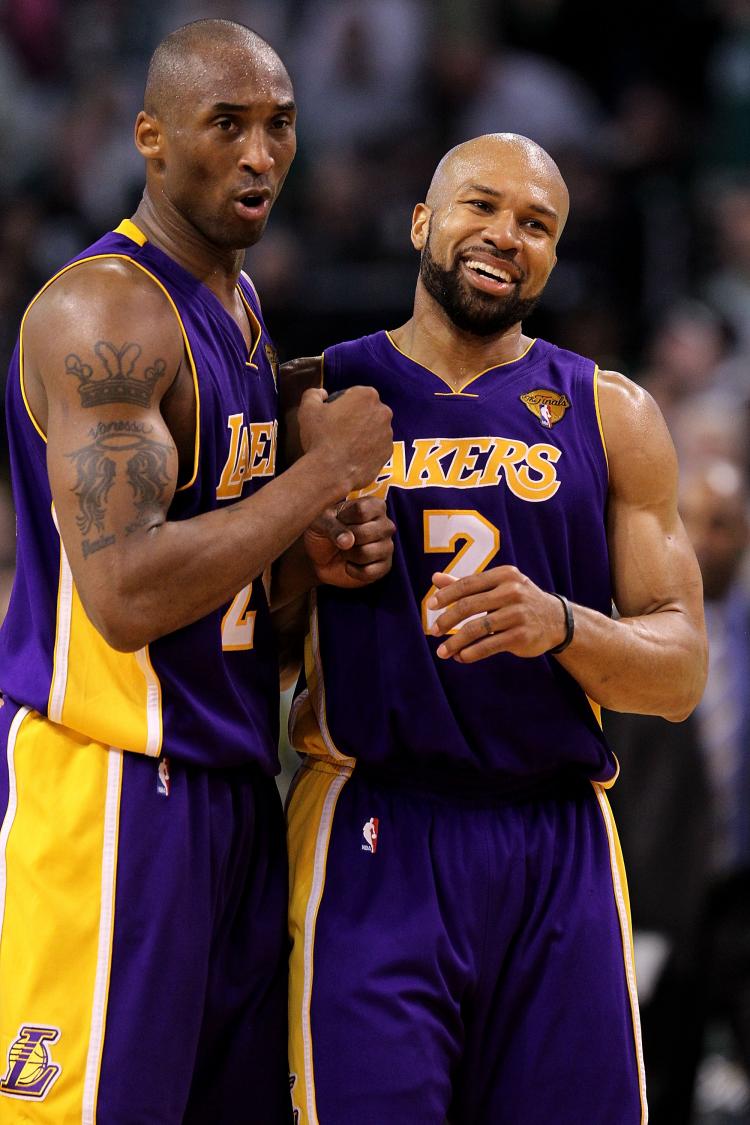 The Lakers' Derek Fisher (right) carried his team down the stretch to a 91-84 win over the Boston Celtics on Tuesday. (Ronald Martinez/Getty Images)