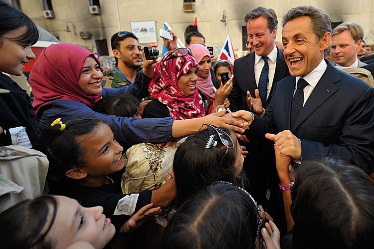 France's President Nicolas Sarkozy (R) and Britain's Prime Minister David Cameron (2ndR) shake hands with people in the crowd in Benghazi September 15. David Cameron and Nicolas Sarkozy saluted a 'free Libya' but warned that Moamer Kadhafi remained a danger, on the first visit by foreign leaders to the North African nation since the despot was toppled. (PHILIPPE WOJAZER/AFP/Getty Images)