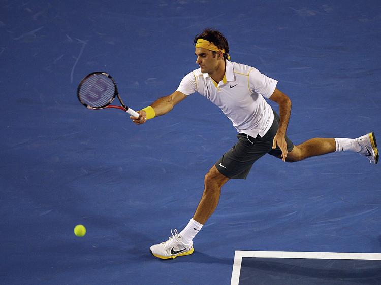 WORKING FOR THE WIN: Roger Federer plays a forehand in his second-round match against Gilles Simon at the 2011 Australian Open. (Mark Dadswell/Getty Images)