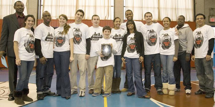 PROJECT FEED ME: A young 'Obama-like' leader Patrick Alvarez founded Project Feed Me last year. He and his all college freshman team handed out free Thanksgiving turkeys in Harlem on Tuesday. Alvarez stands behind his team (third from left).  (Angelo Rivera)