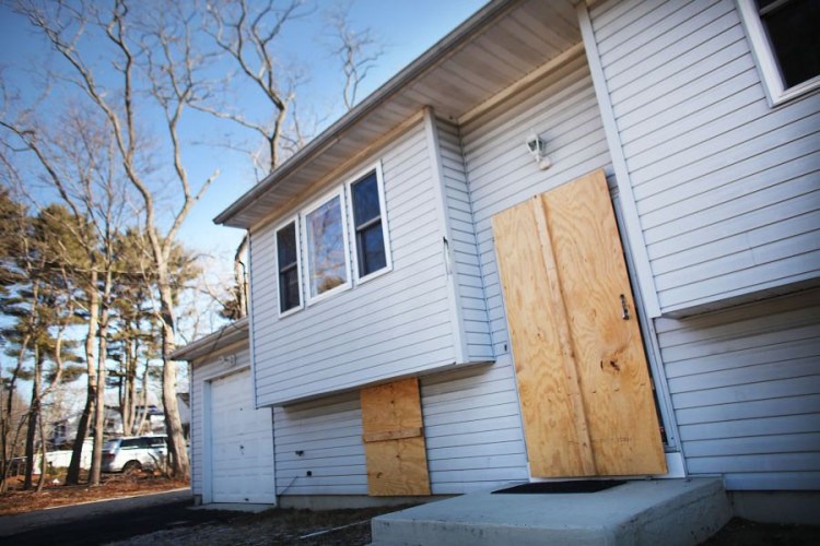 A â��Public Auctionâ�� sign is posted in front of a foreclosed home for sale in Richmond, Calif. (Justin Sullivan/Getty Images)