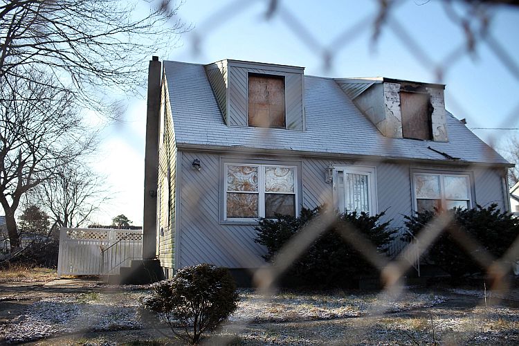 A foreclosed home stands boarded up on Feb. 9 in Islip, NY