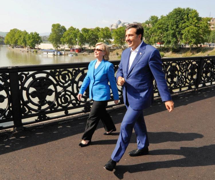 Georgia's President Mikheil Saakashvili (R) and U.S. Secretary of State Hillary Clinton take a walk during their meeting in Tbilisi on July 5. Clinton reassured Georgia with a pledge of continued support and has criticized Russia's occupation of two breakaway Georgian regions. (Irakli Gedenidze/AFP/Getty Images)