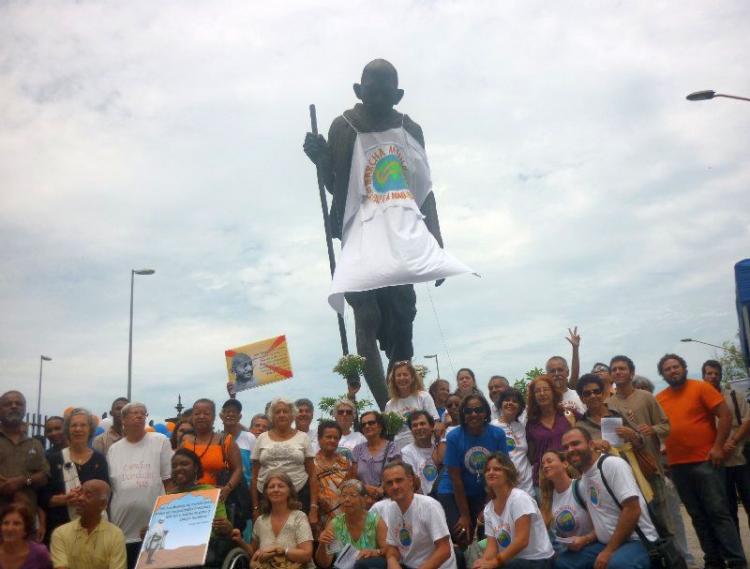 A statue of Gandhi was dressed in the World March's T-shirt at the rally.  (Felipe Santiago/The Epoch Times )