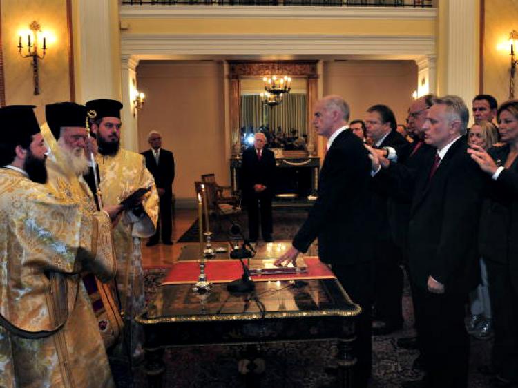 Greece's newly appointed Prime Minister and Foreign Minister George Papandreou (C) swears in during a ceremony at the Greek Presidency on October 7, 2009. (Aris Messinis/AFP/Getty Images)