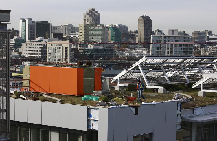 A construction worker walks on a green roof at the 2010 Athletes Village on Nov. 4, 2009, in Vancouver, Canada, host city of the 2010 Olympic Winter Games which began on Feb. 12, 2010. (Jeff Vinnick/Getty Images)