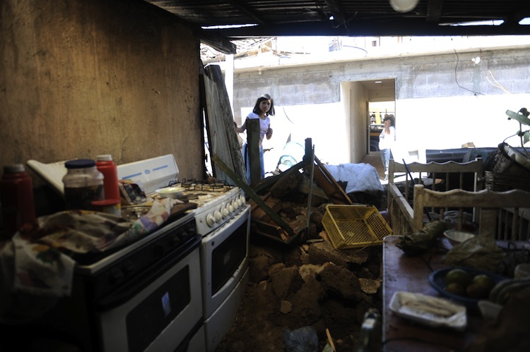 A girls looks inside a house damaged by an earthquake in San Marcos, 160 miles from Guatemala City, on Nov. 8, 2012. A 7.4-magnitude earthquake rocked southwestern Guatemala on Wednesday, killing 48 people and injuring another 150 while more were missing as homes crumbled. (Johan Ordonez/AFP/Getty Images) 