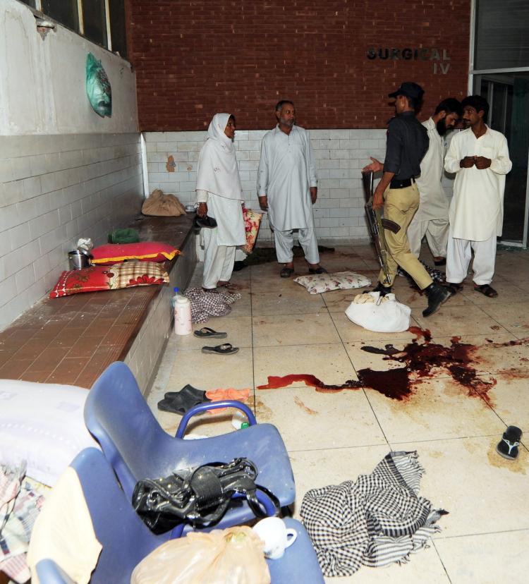 A Pakistani policeman examines the room of a hospital room following the gunmen attack at the Jinnah Hospital in Lahore on May 31. The Gunmen opened fire at a Pakistan hospital where victims of attacks on Ahmadi mosques were being treated killing 12. (Arif Ali/AFP/Getty Images)