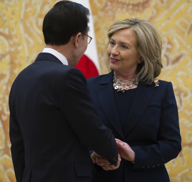 CLOSE TO A DEAL: South Korean President Lee Myung-bak shakes hands with Secretary of State Hillary Clinton during their meeting at the Presidential Blue House in Seoul on April 17. Clinton told South Korean officials that a long delayed free trade deal was almost sealed. (Saul Loeb/Getty Images )
