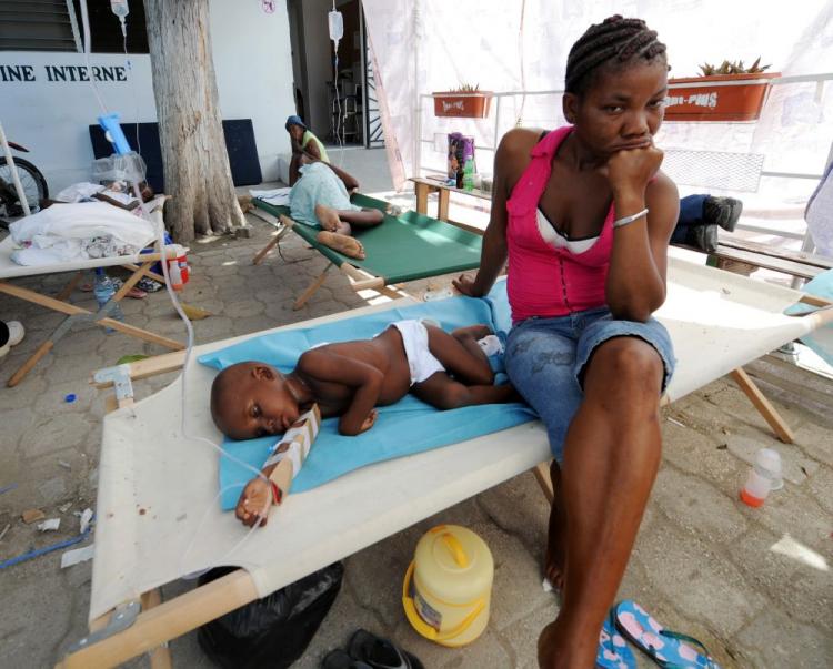 Sick patients and their families wait at the St. Nicolas Hospital in St. Marc, north of Port-au-Prince on Oct. 24. Haiti's cholera crisis deepened Sunday as the first cases of cholera in the capital raised fears that an epidemic could infiltrate Port-au-Prince's squalid tent cities and spawn a major health disaster. (Thony Belizaire/AFP/Getty Images)