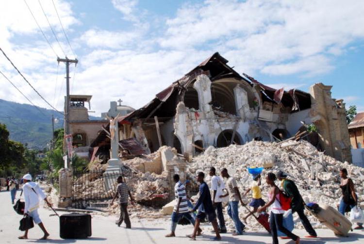 People walk by the collapsed Sacre Coeur Church in Port-au-Prince, on January 14, 2010, following the devastating earthquake that rocked Haiti on January 12. (Thony Belizaire/AFP/Getty Images)