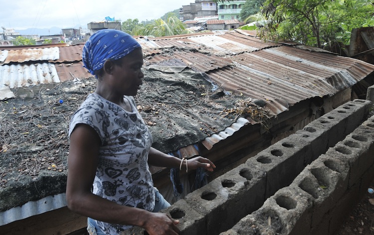 A woman works on her house after recent floods in Vertieres, suburb of the city of Cap-Haitian, Haiti, on Nov. 11, 2012. (Thony Belizaire/AFP/Getty Images)