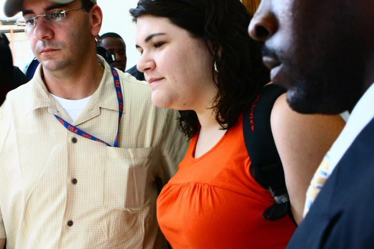 U.S. missionary Charisa Coulter, flanked by a U.S. Embassy official (L) and her lawyer (R), is freed from a Port-au-Prince police station March 8 after a judge orders her release. (Clarens Renois/AFP/Getty Images)