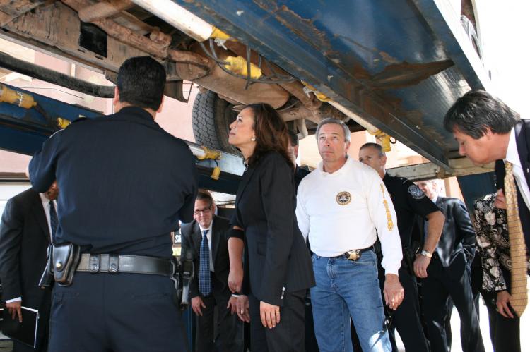 Attorney General Kamala D. Harris inspects a car used to smuggle drugs at the Calexico port of entry. (Courtesy of Calif. Attorney General's Office)